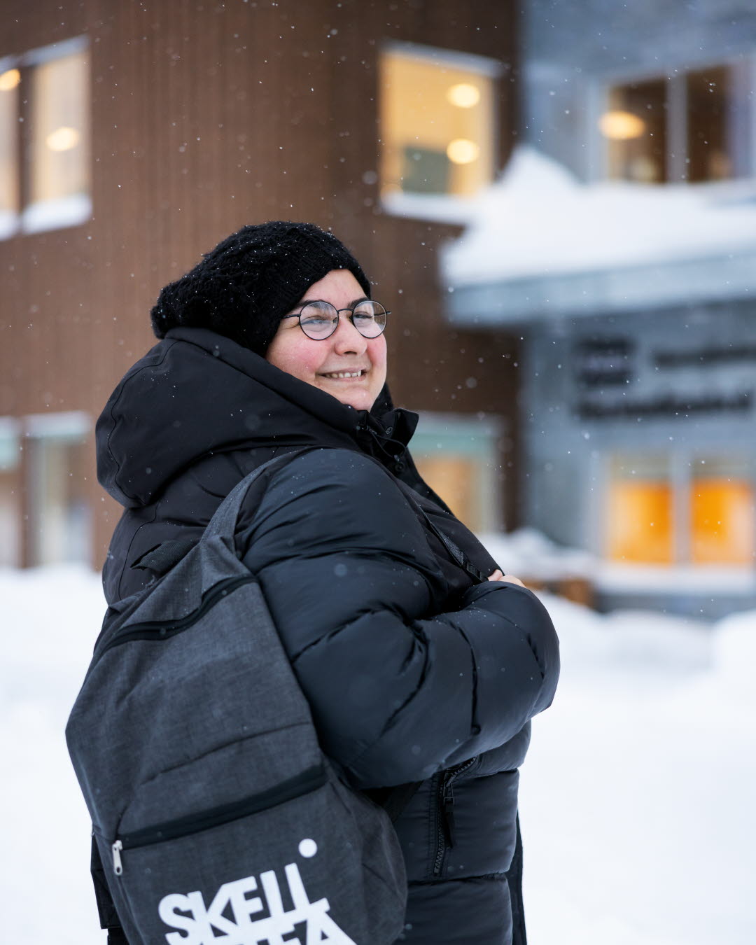 Gulgun Caner står i vinterkläder utanför skolan där hon arbetar