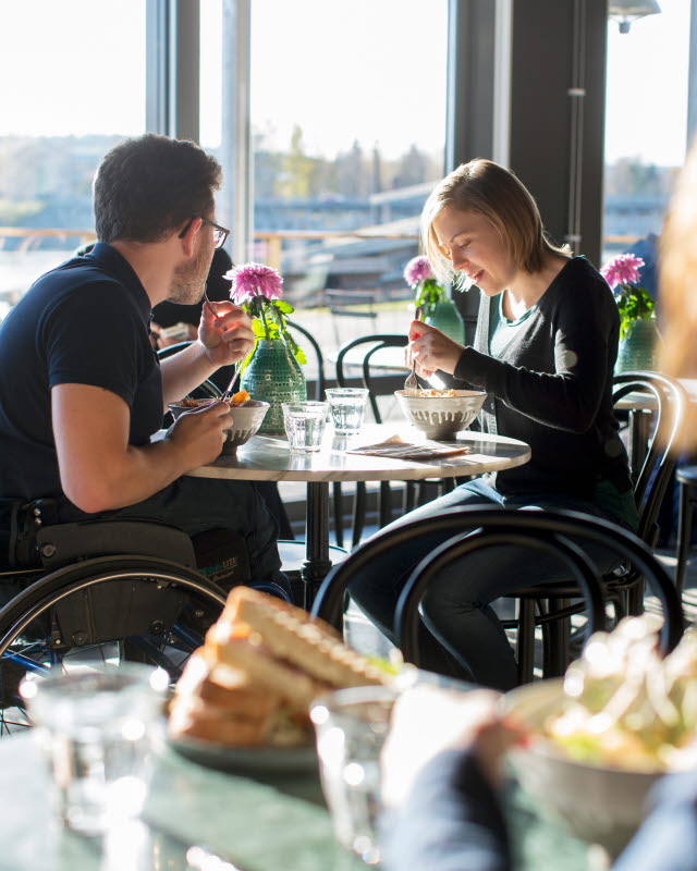 En tjej och en kille äter mat på en restaurang