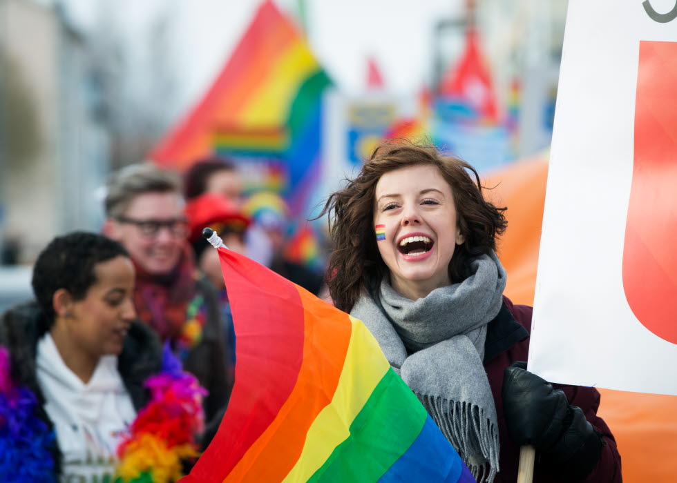 Girl waving the pride flag at the pridefestival in Skellefteå